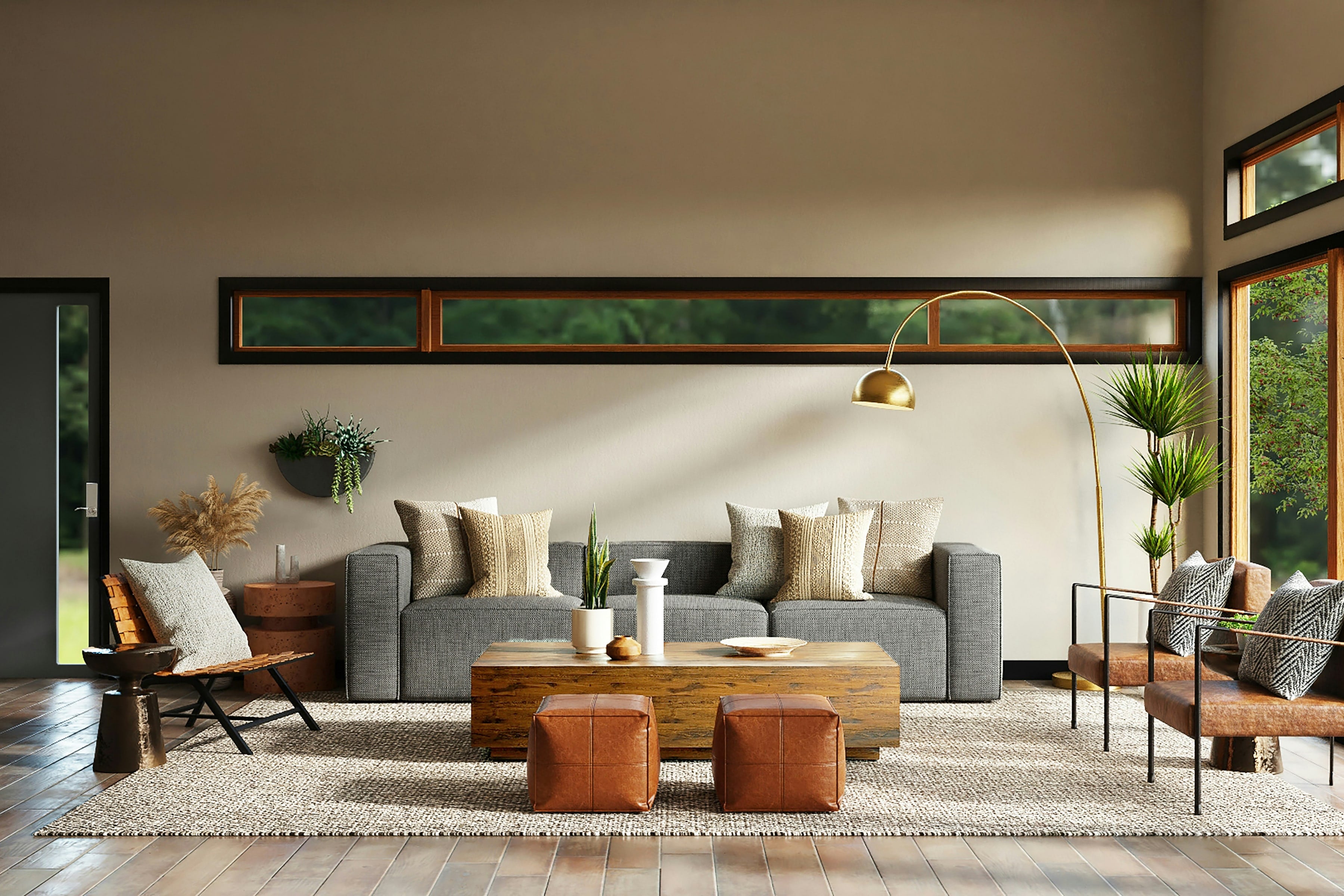A warm living room with a gray sofa, leather ottomans and a long wooden coffee table
